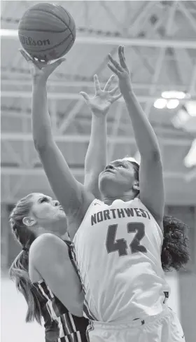  ?? STAFF PHOTO BY C.B. SCHMELTER/TIMES FREE PRESS ?? Northwest Whitfield’s Jada Griffin shoots in front of Heritage’s Reagan Armour during Friday night’s Region 6-AAAA game in Tunnel Hill, Ga. Griffin finished with 24 points, seven rebounds and five steals to lead the Lady Bruins to a 58-45 win that...