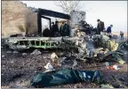  ?? ROUHOLLAH VAHDATI — GETTY IMAGES ?? People stand near the wreckage of a Ukrainian plane that crashed shortly after taking off from the Tehran airport on Wednesday. All 176 people on board were killed.