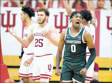  ?? DARRON CUMMINGS/AP ?? Michigan State's Aaron Henry (0) reacts after hitting a shot and getting fouled on Saturday. Henry tied a career high with 27 points in the Spartans’ win over the Hoosiers.