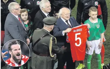  ??  ?? Irish President Michael D Higgins holds up the Derry City shirt of Ryan McBride (inset) at the Aviva Stadium