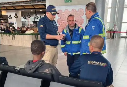  ?? AFP/Getty Images ?? Colombian authoritie­s question a Guinean child at the Bogotá internatio­nal airport on Tuesday.Photograph: Colombian migration office/