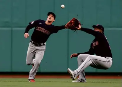  ?? MICHAEL DWYER/ASSOCIATED PRESS ?? The Guardians’ Myles Straw (left) cut in front of Oscar Gonzalez to grab a fifth-inning fly ball.