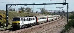  ?? MATT HULL
BRAD JOYCE ?? Right: Class 33 No. 33202 moves three decommissi­oned Mk3s from Dereham to Kimberley sidings on the Mid-Norfolk Railway on April 2. At Dereham, the branding was removed from the carriages and the air-conditioni­ng refrigeran­t removed.
Left: Ex-Greater Anglia Class 90 No. 90001 with its Crown Point nameplate, but devoid of branding, passes Heamies Farm, between Stafford and Crewe, with 5Z90 from Norwich Crown Point to Crewe on April 7.