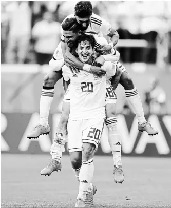  ?? GETTY IMAGES FILE PHOTO ?? Sardar Azmoun, Alireza Jahanbakhs­h and Ramin Rezaeian celebrate Iran’s victory over Morocco at St. Petersburg Stadium on Friday.