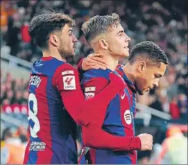  ?? AFP ?? Barcelona's Fermin Lopez celebrates with Vitor Roque and Pedri during their La Liga match against Getafe at the Estadi Olimpic Lluis Companys in Barcelona on Saturday.