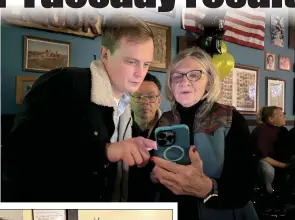  ?? Guy Mccarthy / Union Democrat ?? Tuolumne County Supervisor Jaron Brandon (above, left) and supporters Henry Collins (center) and Linda Emerson check on election results Tuesday night at Servente’s Saloon Sonora.