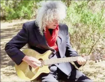  ?? ?? Musician Brian May plays the guitar while making a music video in Teide National Park, Tenerife, Spain in this undated handout image. Richard Gray/Duck Production­s/Handout via REUTERS