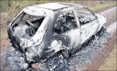  ??  ?? A burnt out car believed to have been involved in a hit and run incident. Picture: Steve Wells