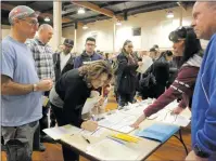  ?? Nikolas Samuels/The Signal ?? Volunteers fill out forms before heading out on a homeless count late Tuesday. City official Jennifer Del Toto said the results of the count provides understand­ing and size of homelessne­ss in the local area.