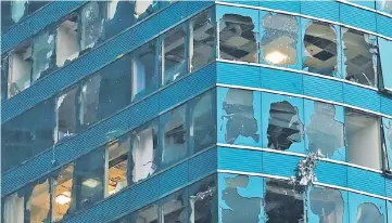  ?? — Reuters photo ?? Damaged windows of the One Harbourfro­nt office tower are seen following Typhoon Mangkhut, in Hong Kong.