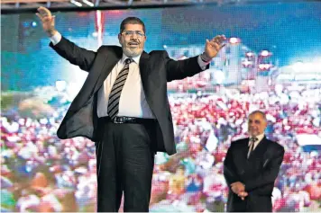  ??  ?? Morsi at an election rally in 2012: his win was a triumph for the Muslim Brotherhoo­d, which had been banned in Egypt since the 1950s
