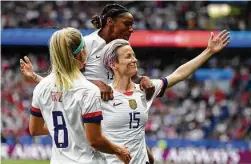  ?? Franck Fife / AFP/Getty Images ?? True to coach Jill Ellis’ words, forward Megan Rapinoe, right, and the U.S. women have thrived under the pressure of defendig the title.