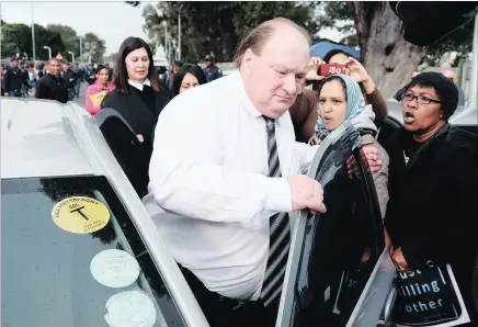  ?? PICTURE: IAN LANDSBERG ?? Protesters shout at Alan Raves, accused of being part of a gun smuggling syndicate, outside the Bellville Magistrate’s Court yesterday.