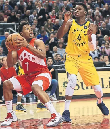  ?? RENÉ JOHNSTON TORONTO STAR ?? Raptors guard Kyle Lowry, back on the court after missing 10 of the previous 11 games, goes up against Pacers guard Victor Oladipo on Sunday at Scotiabank Arena. Lowry had 12 points as the Raptors won 121-105.