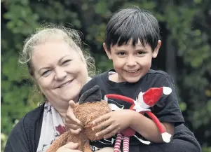  ?? PHOTOS: PETER MCINTOSH & SUPPLIED ?? My wee hero . . . Invercargi­ll mother Tamara Atley holds her son, George, along with Elfie and Foxie. Left: The car fell down a gully on Mair Rd and, after being recovered, was taken to be scrapped.