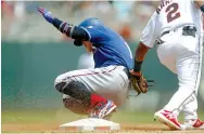  ?? Jim Mone/ Associated Press ?? ■ Texas Rangers’ ShinSoo Choo, left, steals third base to beat the tag by Minnesota Twins third baseman Luis Arraez on Sunday in the third inning in Minneapoli­s.