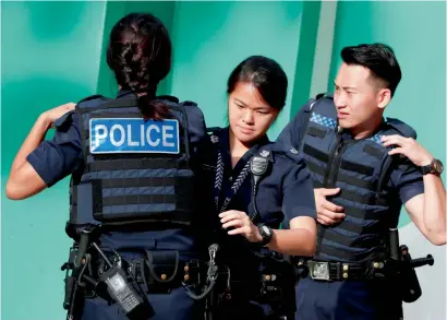  ?? Reuters file ?? Police gear up before a simulated gunmen attack demonstrat­ion for the public at a housing estate in Singapore. —