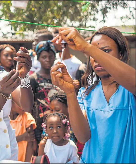  ?? Photograph: WHO/E Soteras Jalil ?? the standard yellow fever dose as a short-term emergency measure in Kinshasa