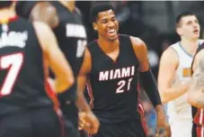  ??  ?? Miami center Hassan Whiteside, center, smiles after hitting a basket against Denver on Wednesday. David Zalubowski, The Denver Post