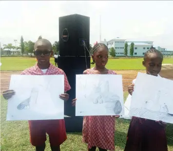  ??  ?? First and second best in drawings, both from Corona school, with the third position pupil from Smiley Kids Internatio­nal School