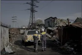  ?? ?? Ukrainian electrical workers inspect a new power line replacing one destroyed months earlier in Kyiv, on March 8.