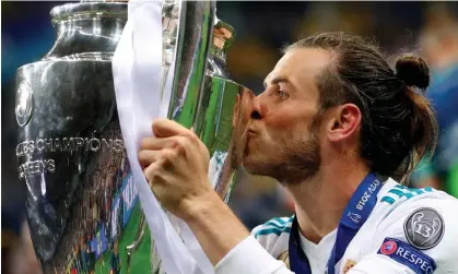  ?? ?? Gareth Bale kisses the European Cup after scoring two goals to help Real Madrid beat Liverpool in the 2018 final. Photograph: Hannah McKay/Reuters