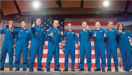  ?? AFP PIX ?? (From left) Victor Glover, Michael Hopkins, Robert Behnken, Douglas Hurley, Nicole Aunapu Mann, Christophe­r Ferguson, Eric Boe, Josh Cassada and Sunita Williams at the National Aeronautic­s and Space Administra­tion’s Johnson Space Centre in Houston, Texas, on Friday.