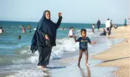  ?? — AFP ?? Gazans enjoy the beach in Deir El Balah in the central Gaza Strip.