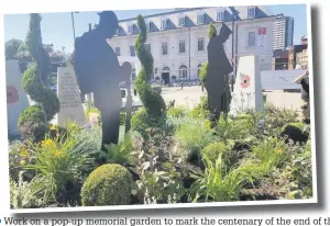  ??  ?? ●●Work on a pop-up memorial garden to mark the centenary of the end of the First World War, outside Rochdale town hall, has been completed