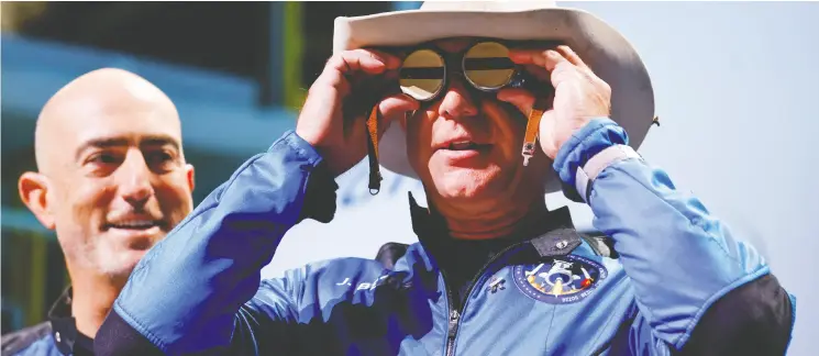  ?? JOE SKIPPER / REUTERS ?? Jeff Bezos wears goggles owned by Amelia Earhart which he carried with him when he flew on Blue Origin’s inaugural flight to the edge of space on Tuesday.