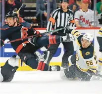  ?? KARL B DEBLAKER/AP ?? Carolina Hurricanes’ Max Domi (13) is tripped up by Boston Bruins’ Erik Haula (56) during the first period of Game 5 of an NHL hockey Stanley Cup first-round playoff series on Tuesday in Raleigh, N.C.,