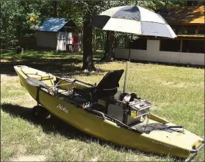  ?? Arkansas Democrat-Gazette/BRYAN HENDRICKS ?? A length of PVC and a golf umbrella combine to create a canopy in protecting kayak anglers from the summer sun.
