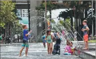  ?? BROOK MITCHELL / GETTY IMAGES ?? Families take refuge from the heat at Darling Harbour on Monday in Sydney after the city was the hottest place on earth on Sunday.