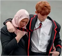  ?? Reuters ?? A student and a woman attend the burial ceremony of a victim of the mosque attacks in Christchur­ch, on Thursday. —