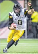  ?? CP PHOTO ?? Hamilton Tiger-Cats quarterbac­k Jeremiah Masoli runs for a first down against the B.C. Lions during the first half of a CFL football game in Vancouver, on Sept. 22.