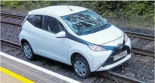  ??  ?? The woman’s car on the tracks after it trundled to a halt beside station platform