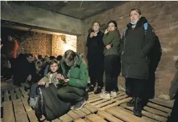  ?? NARIMAN EL-MOFTY AP ?? People shelter undergroun­d following explosions in Lviv, western Ukraine, on Saturday. Lviv had been largely spared since Russia’s Feb. 24 invasion.