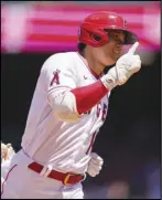  ?? Associated Press ?? HISTORY — Angels designated hitter Shohei Ohtani (17) rounds the bases after hitting a home run against the Baltimore Orioles on Sunday. The two-way player is the first chosen to pitch and hit in the AllStar Game.