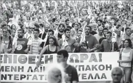  ?? Orestis Panagiotou European Pressphoto Agency ?? UNION MEMBERS rally outside Parliament in Athens to protest the second batch of reforms demanded by Greece’s creditors as lawmakers prepared to vote.