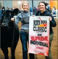  ?? to courtesy Cathy Schmitz. ?? RIGHT: Lynsey (on the left) and Lacey Schmitz after winning supreme female with their Angus heifer at the 2020 North Star Classic Livestock Show. The women plan on showing at this year’s NDWS; the junior cattle show will be held at 8 am on March 14. Pho