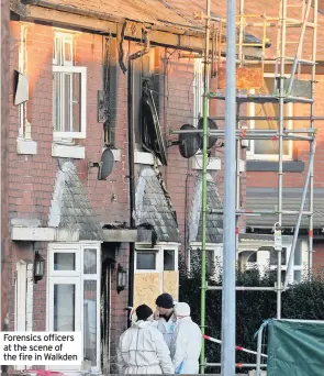  ??  ?? Forensics officers at the scene of the fire in Walkden