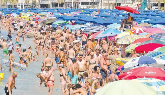  ?? Photo: Reuters ?? People cool off at the beach in Benidorm, Spain.