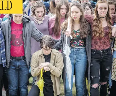  ?? BENJAMIN ZACK / STANDARD-EXAMINER VIA AP ?? Student protesters at Weber High School in Pleasant View, Utah, observe a moment of silence as the names of the victims from the Marjory Stoneman Douglas High School shooting are read aloud on Wednesday.