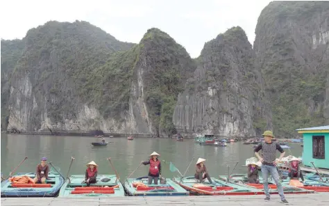  ?? TOURIST ATTRACTION: — AFP ?? Boatpeople waiting for tourists on their small bamboo boats on Halong Bay in the northeaste­rn province of Quang Ninh. An Unesco World Heritage site with around 2,000 islets, Halong Bay is one of the main tourist destinatio­ns in northern Vietnam.