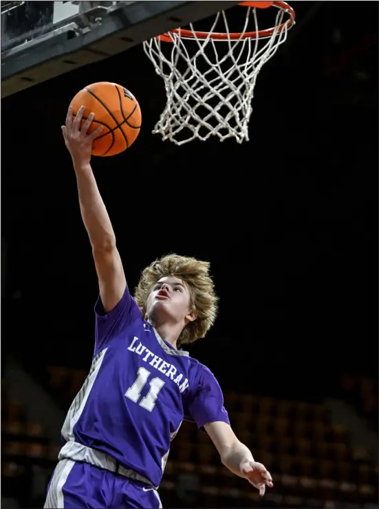  ?? AARON ONTIVEROZ — THE DENVER POST ?? Braydon Jacob of the Lutheran Lions scores against the Alamosa Mean Moose during the first half of the teams’ Great 8 showdown at the Denver Coliseum on Friday. Lutheran prevailed in overtime.