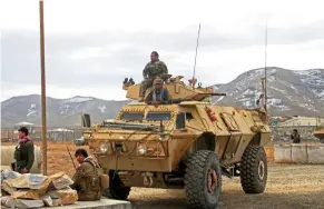  ??  ?? Heightened alert: Afghan National Army soldiers keeping watch outside of a military compound after a car bomb blast killed 30 on the outskirts of Ghazni city, Afghanista­n. — Reuters