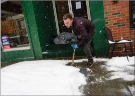  ?? KRISTOPHER RADDER — THE BRATTLEBOR­O REFORMER VIA AP ?? Mikey Reynolds, an employee at The Works on Main Street in Brattlebor­o, Vt., shovels the sidewalk in front of the restaurant Saturday.