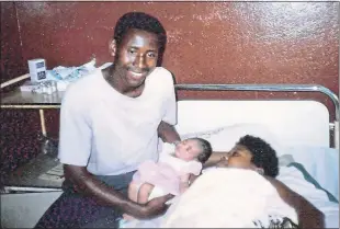  ??  ?? Proud dad Augustin holds baby Regina as his wife Catherine recovers in Freetown hospital bed on March 18, 1993, just a day after Keith Thomson paid for an emergency caesarean operation. Below, Augustin, Regina and Catherine safe in Guinea being helped to flee war-torn Sierra Leone the greatest gifts