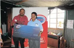  ??  ?? GRATITUDE: Algoa FM Presenter Brian Ndevu hands over voucher of R55 000 raised to install ablution facilities at Rising Sun Daycare Centre in Duncan Village.