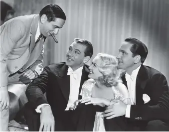  ??  ?? Ernst Lubitsch, Gary Cooper, Miriam Hopkins, and Fredric March on the set of Design for Living, 1933